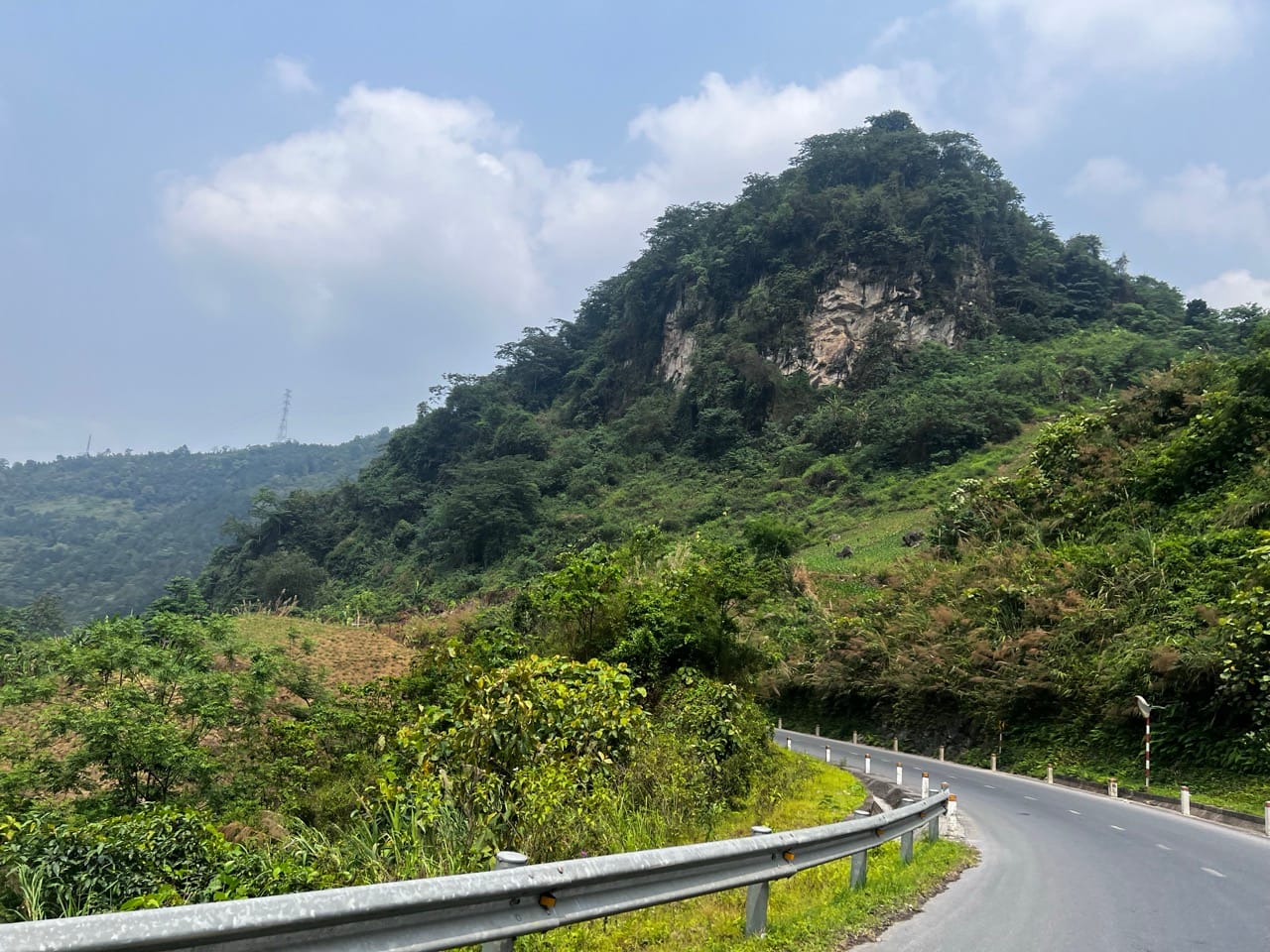 green mountain with flat top rising above valley near Lao Cai, Vietnam