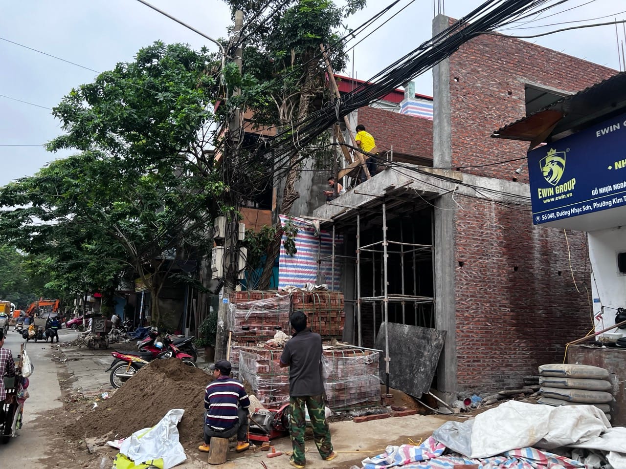 new building construction next to older tube houses in Lao Cai