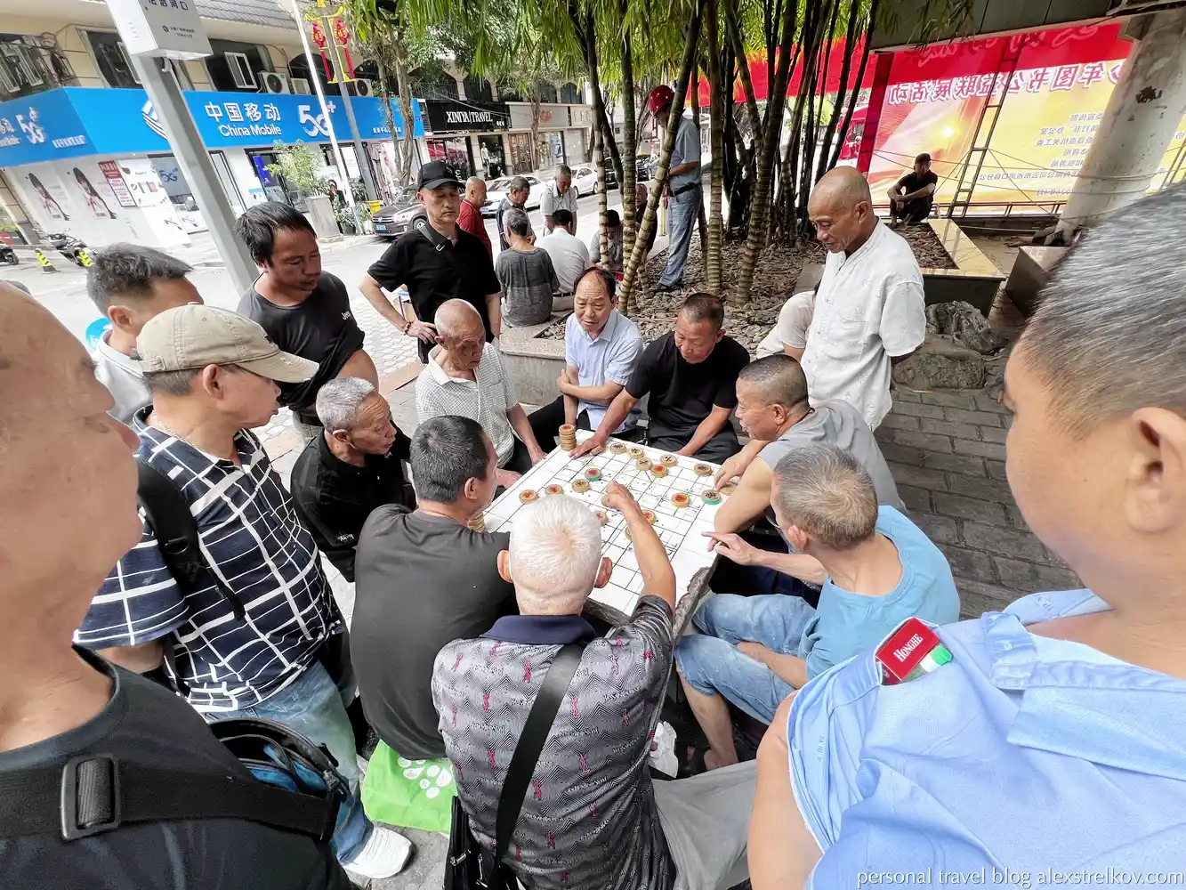 men playing xiangqi Chinese chess on street in Hekou 