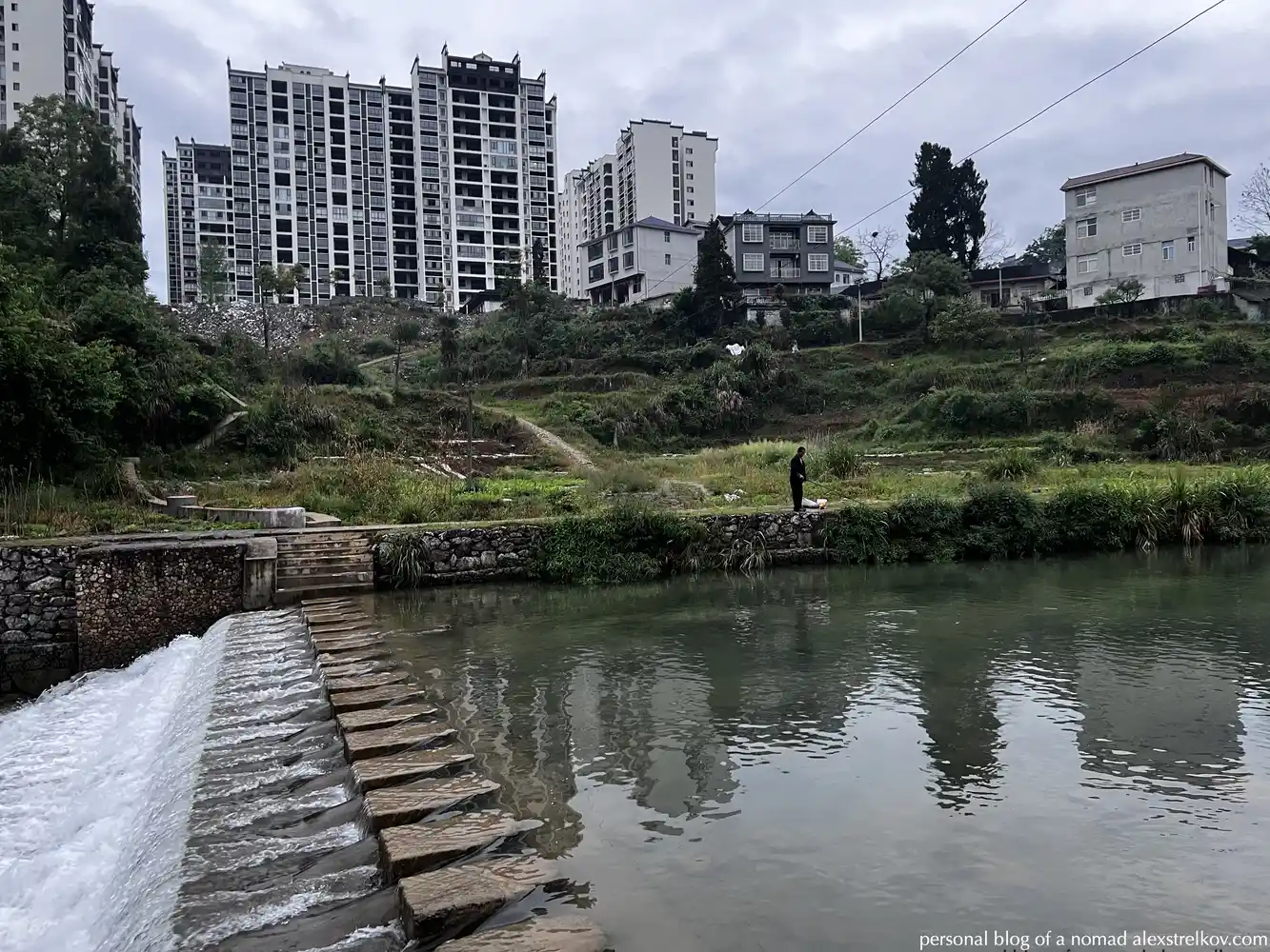 river in Furongzhen at dusk, lights reflected in water 